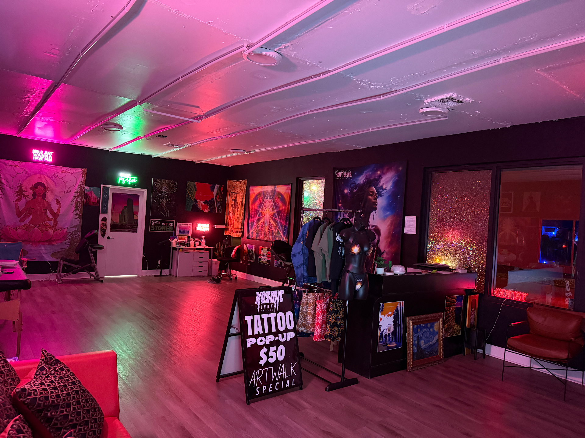 Kosmic Inkk studio interior with neon lights and art displays