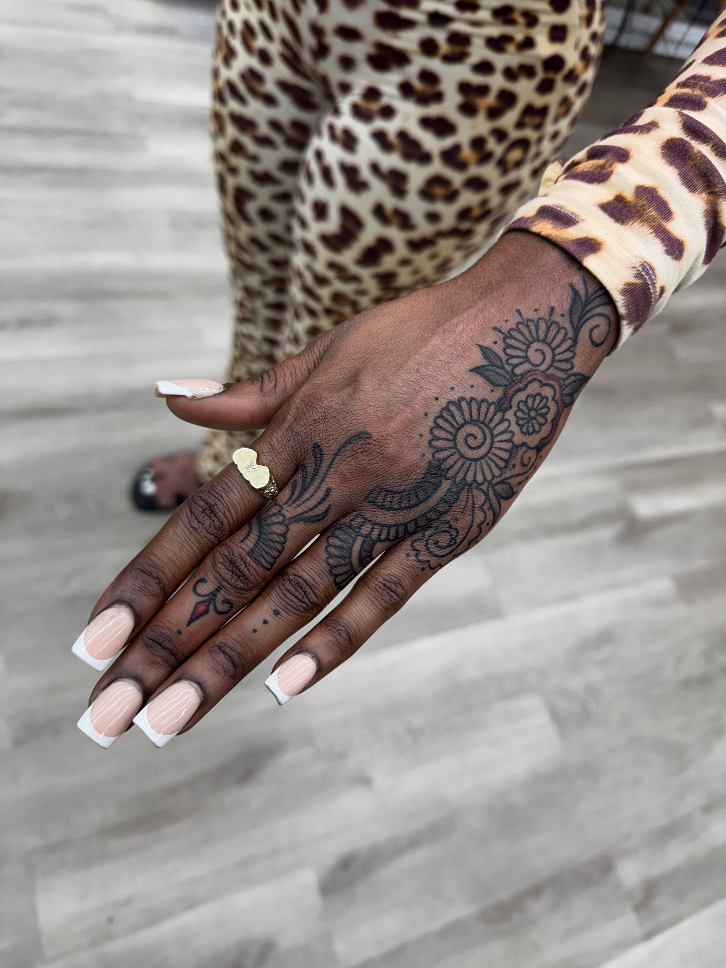 Henna-style ornamental black linework hand and finger tattoo