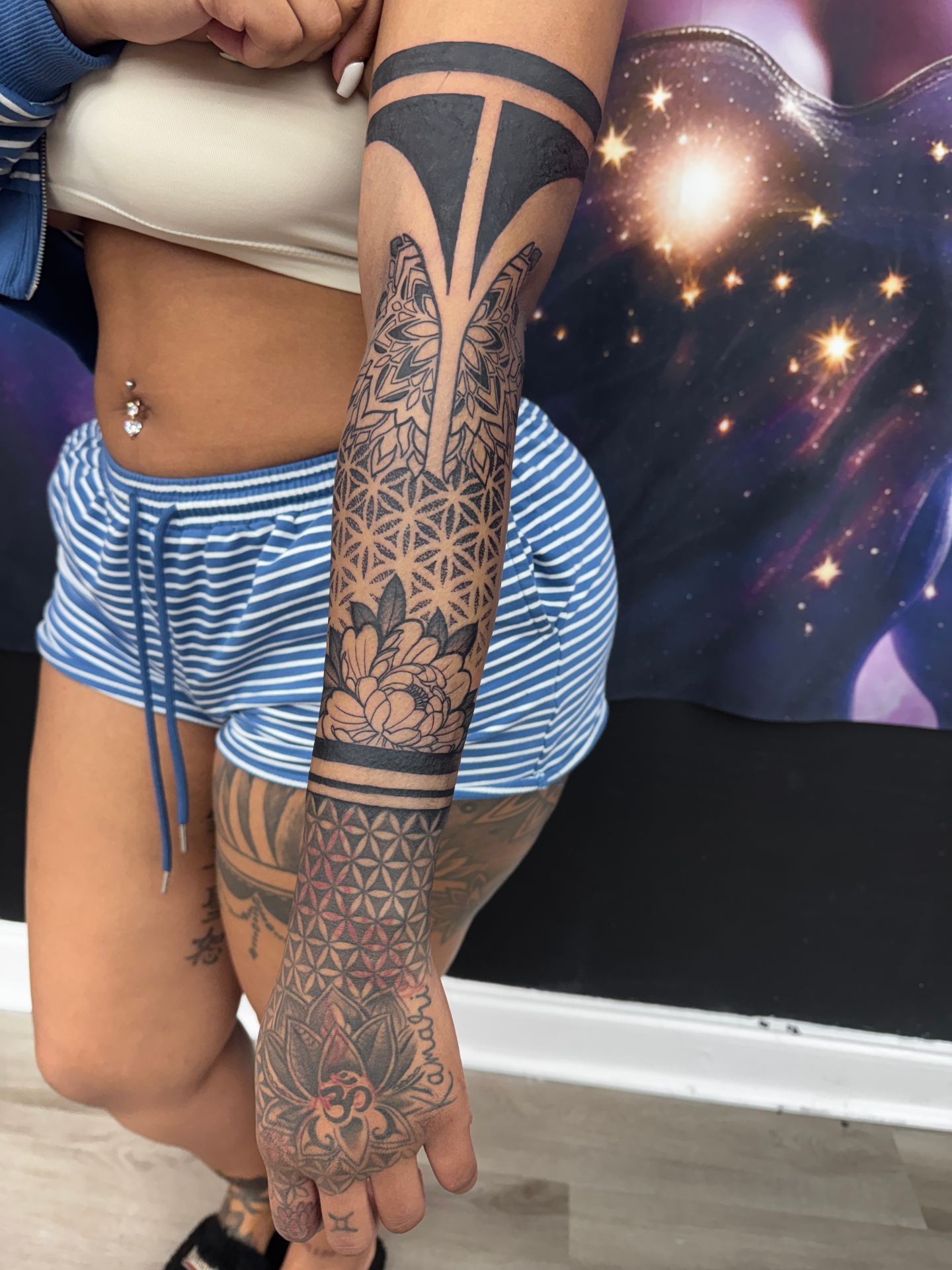 Geometric mandala and floral sleeve tattoo with flower of life pattern