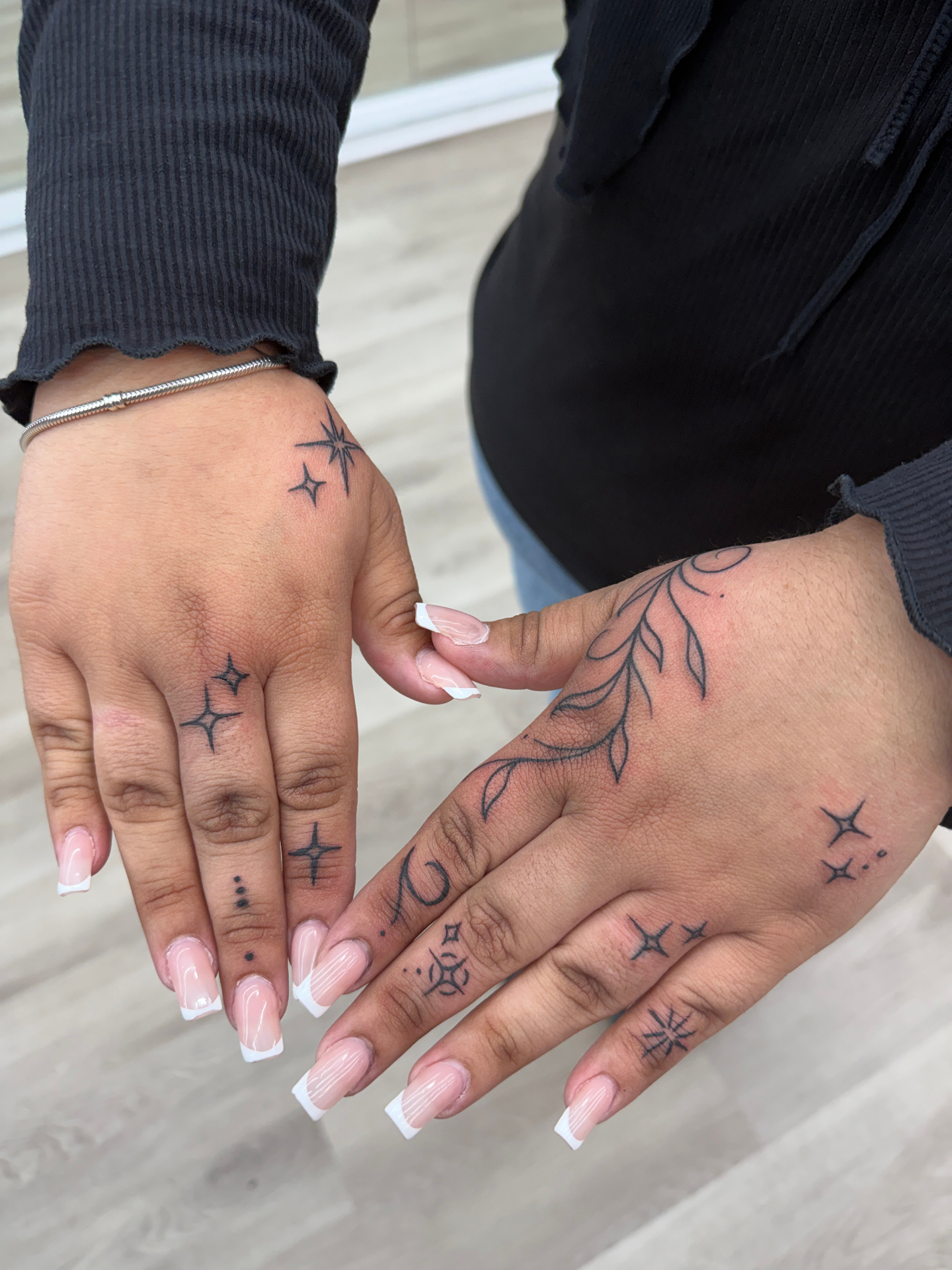 Fine-line hand tattoo work